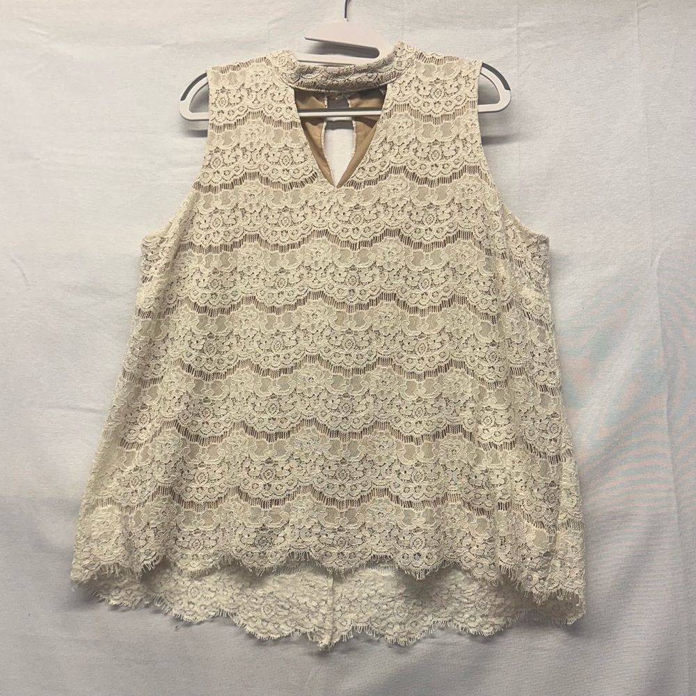 This is a Rose & Olive cream‎ lace sleeveless blouse. Size XL